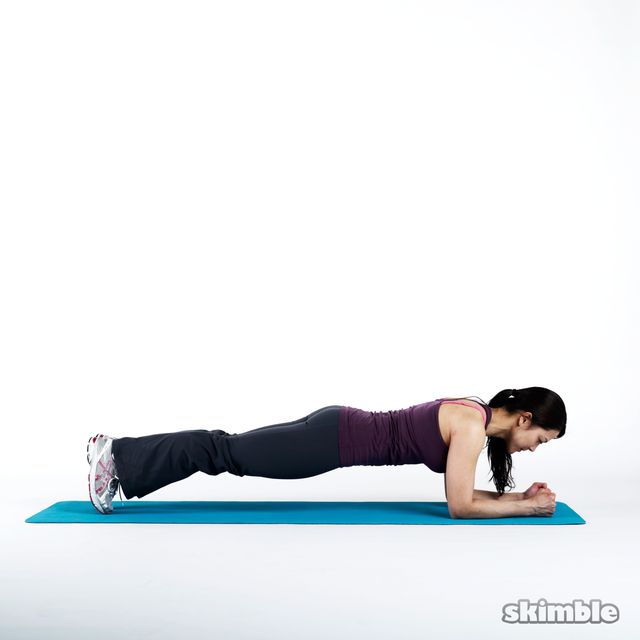 Lie on your stomach with your toes tucked in. Press your forearms on the ground and lift your body into a straight line.