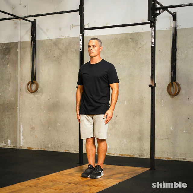 Start in a standing position with your feet together and your arms by your sides.