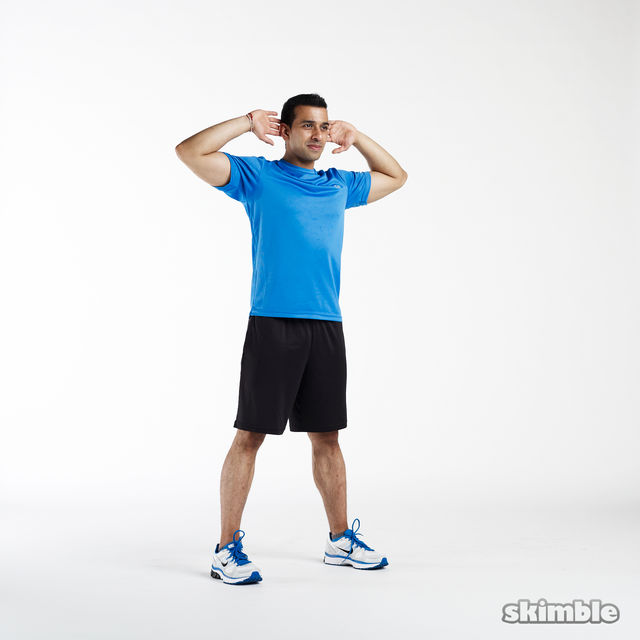 Start with your hands behind your head and your feet hip-width apart.