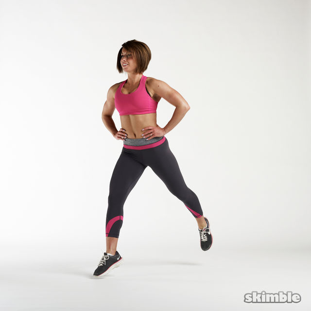 Start standing in a lunge position with your hands on your hips.