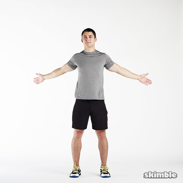 Stand with your feet hip-width apart and with your arms raised at your sides.